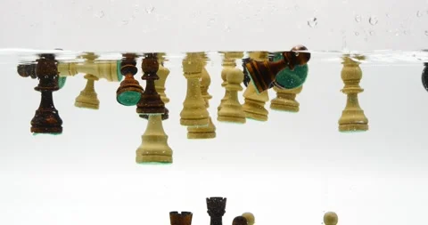 Many chess pieces falling into water isolated on white black and white chest pie Video stock 219288106