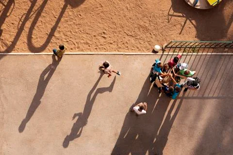Many children play ball in the yard on the Playground on a Sunny clear summer Stock Photos