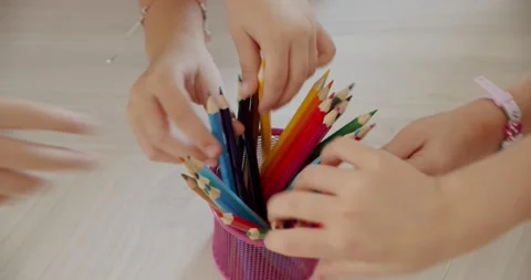 Many children's hands take colored pencils, top view Stock Footage 140218101