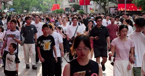 Many Chinese people walking down a busy pedestrian street Stock Footage 327648662