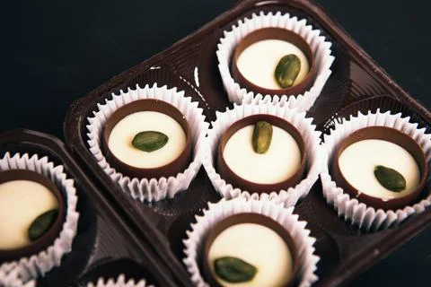 Many chocolate sweets with  Pistachio on black background Stock Photos