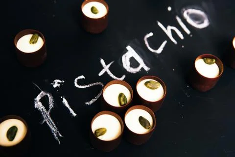 Many chocolate sweets with  Pistachio on black background Stock Photos