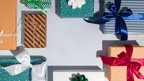 Many Christmas gift boxes with red ribbon and candy on grey background. Mockup. Stock Footage 221790327