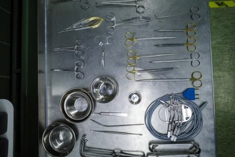 Many cleaned instruments for performing vascular surgery lie on a metal table Stock Photos