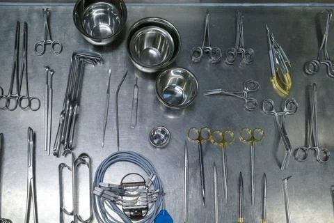 Many cleaned instruments for performing vascular surgery lie on a metal table Stock Photos