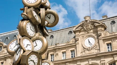 Many clocks, different times with the clock of Saint Lazare in the background. Stock Footage 50027171