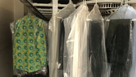 Many clothes on rack in professional dry-cleaner Video stock 118526706