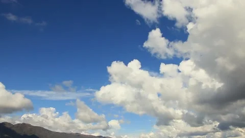 Many clouds in the sky going towards The Twins peaks, from the dam view in th Stock Footage 174004833