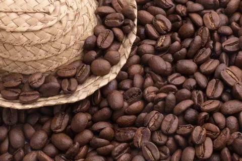 Many coffee beans with straw hat Stock Photos