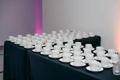 Many coffee cups lined up and ready to receive guests Stock Photos