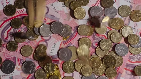 Many coins fall on top of the banknotes Video stock 314278256