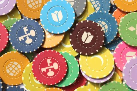 Many colored chips backdrop. Lot multicolor assorted gambling playing chips s Stock Photos