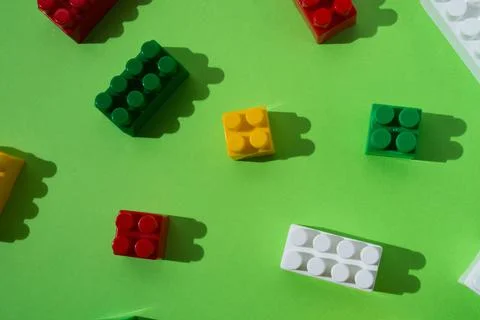 Many colored details of children's constructor, pattern, isolated on green ba 스톡 사진