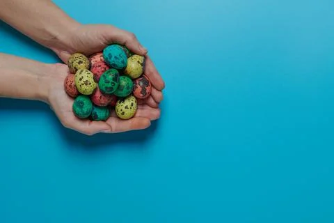Many colored eggs in the palms for easter Stock Photos
