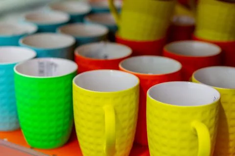 Many colored mugs in the store Stock Photos