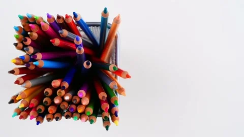 Many colored pencils standing and in metal pen holder on white desk. Top view 動画素材 153103201