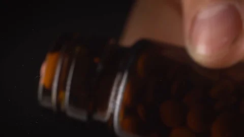 Many colored pills fall from a glass jar Stock Footage 127620183