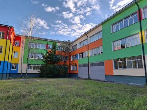 Many-coloured facade of school building Stock Photos