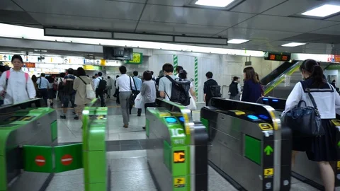 Many Commuters Passing Through Ticket Gates at Train Station in Tokyo, Japan - Stock Footage 105060138