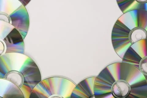 Many compact discs with space text white background Stock Photos