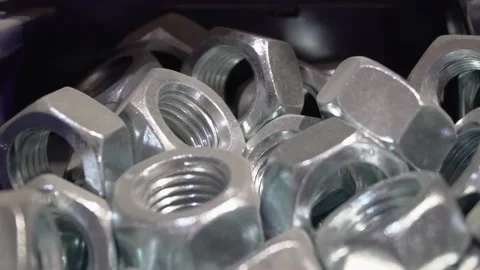 Many construction nuts with holes and threads. Steel nuts for screw fastening. Stock Footage 199943809