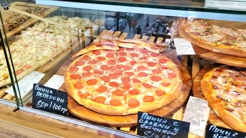 Many cooked packaged pizzas on a special counter 스톡 동영상 275154756