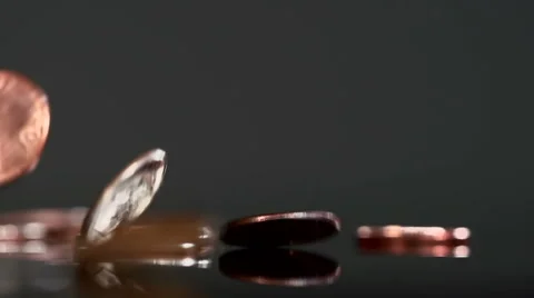 Many copper coins dropping in slow motion against black background Stock Footage 55620477
