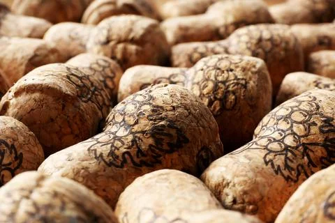Many corks of wine bottles with grape images as background, closeup 스톡 사진