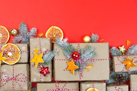 Many craft gift boxes on red background. Christmas holiday package banner Stock Photos