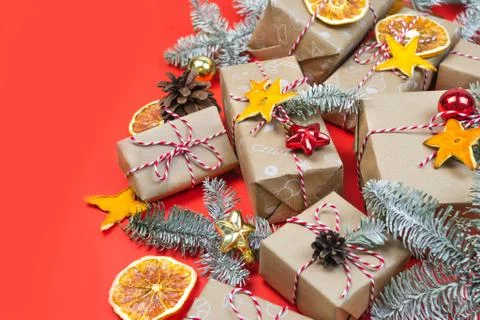 Many craft gift boxes on red background. Christmas holiday package banner Stock Photos
