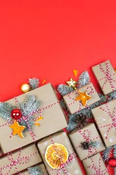 Many craft gift boxes on red background. Christmas holiday package banner Stock Photos