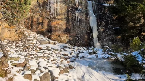 Many crowded massive icicles melting in the spring sun on a mountainside 스톡 동영상 331042657
