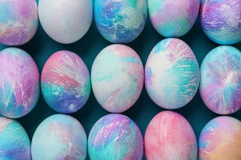 Many decorated Easter eggs on turquoise background, flat lay Stock Photos