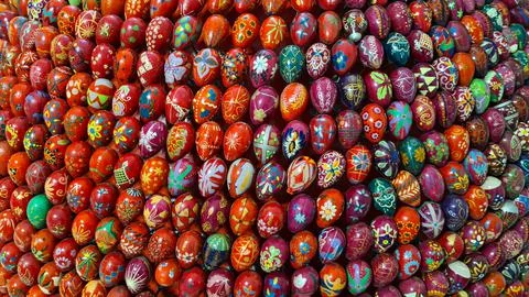 Many decorative Easter eggs painted with beautiful bright colors are stacked  Stock Photos