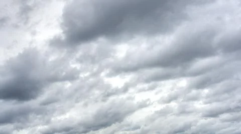 Many dense rain clouds in the overcast sky before the moment of the rain. Stock Photos