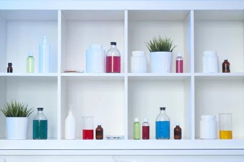 Many different bottles and test tubes with liquids of different colors stand on Stock Photos