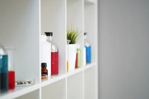 Many different bottles and test tubes with liquids of different colors stand on Stock Photos