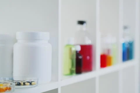 Many different bottles and test tubes with liquids of different colors stand on Stock Photos