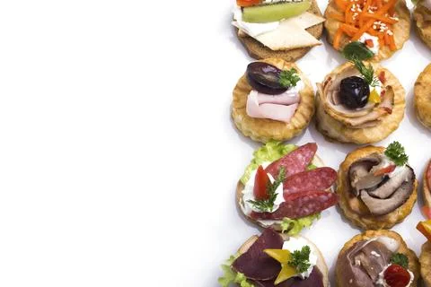 Many different canapes on a white background Stock Photos