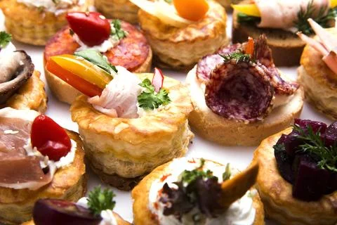 Many different canapes on a white background Stock Photos