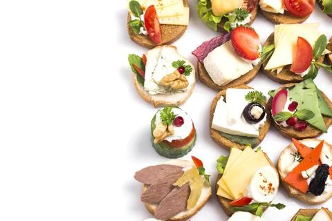 Many different canapes on a white background Stock Photos