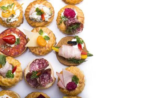 Many different canapes on a white background Stock Photos