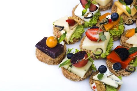 Many different canapes on a white background Stock Photos