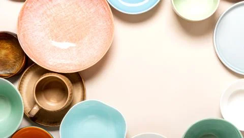 Many different ceramic plates and bowls on a light background Stock Photos