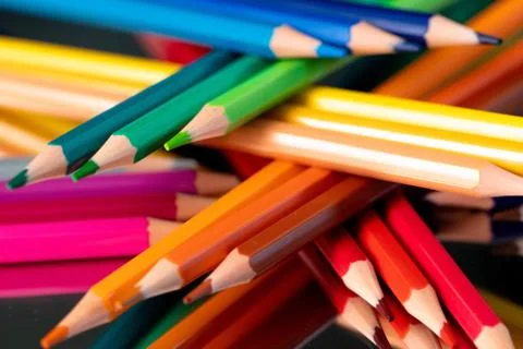 Many different colored pencils reflected on black Stock Photos