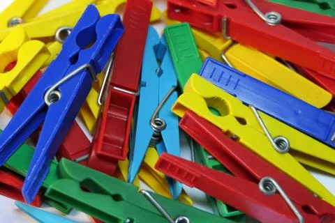 Many different colored plastic clothes pegs close up. Lots of clothespins 写真素材