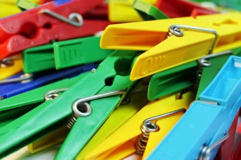 Many different colored plastic clothes pegs close up. Lots of clothespins 写真素材