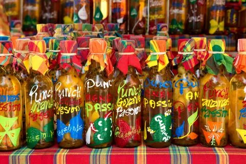 Many different colored punch bottles in a row, Guadeloupe. Stock Photos