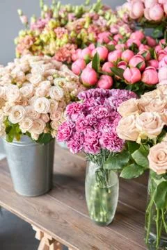 Many different colors on the stand or wooden table in the flower shop. Showcase Stock Photos