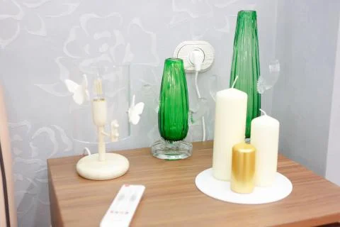 Many different elements of interior design on the bedside table, two green va 스톡 사진